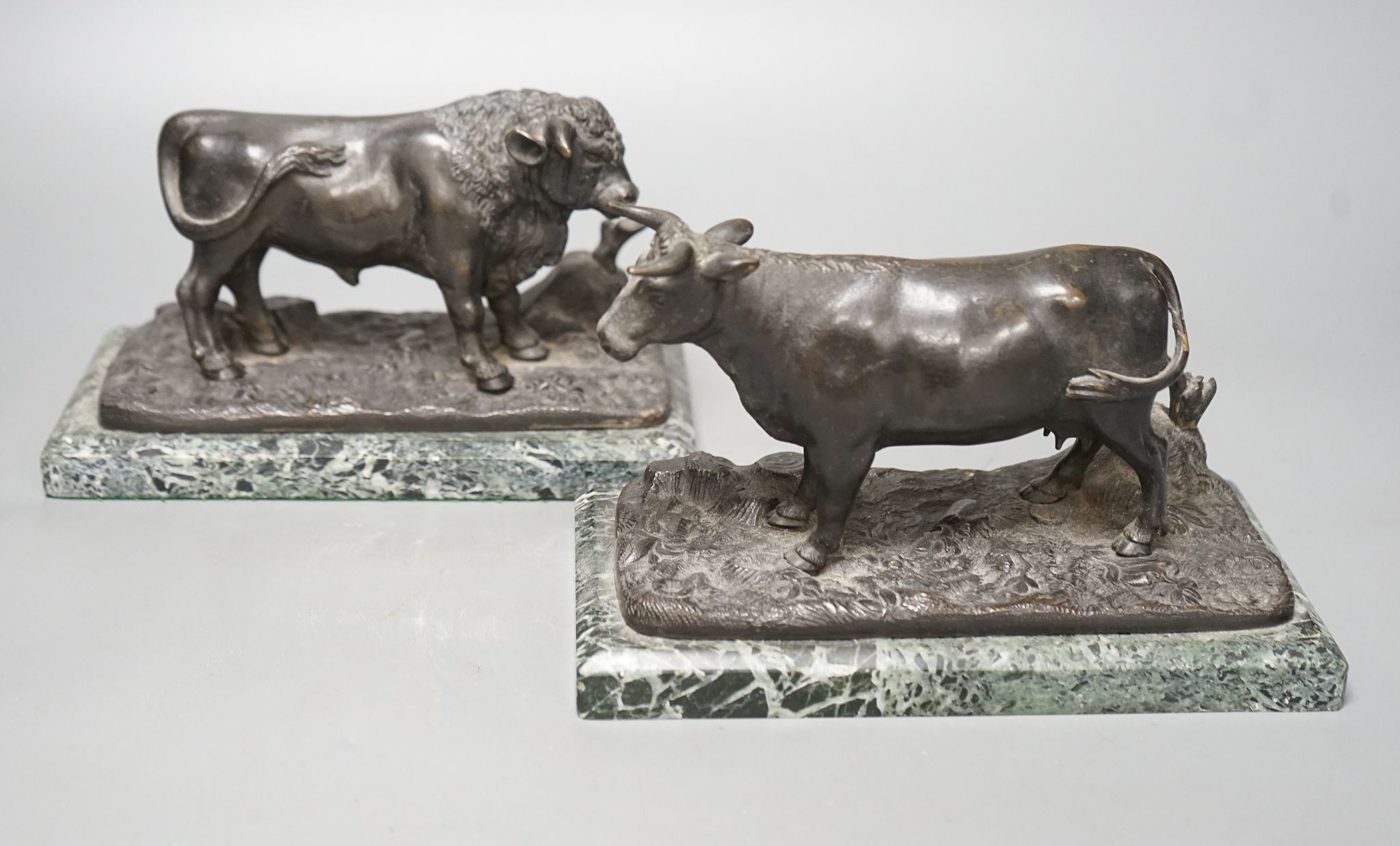 A pair of 20th century bronzes, a cow and a bull, on marble bases, 21cm